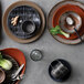 A grey World Tableware stoneware mug on a table.