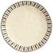 A white Libbey stoneware dinner plate with black dots.