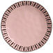 a pink plate with black dots