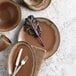 A table set with Libbey Hedonite porcelain plates, bowls, and utensils.