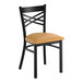 A black metal cross back chair with a light brown vinyl padded seat.