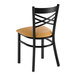 A black metal cross back chair with a light brown vinyl padded seat.
