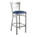 A Lancaster Table & Seating metal bar stool with a blue cushion.