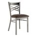 A Lancaster Table & Seating metal cross back chair with a dark brown vinyl padded seat.