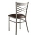 A Lancaster Table & Seating metal cross back chair with a dark brown padded seat.