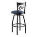 A black Lancaster Table & Seating bar stool with a navy blue padded seat.