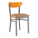 A Lancaster Table & Seating Boomerang clear coat finish chair with light brown vinyl seat and cherry wood back.
