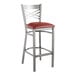 A Lancaster Table & Seating clear coat finish cross back bar stool with a burgundy vinyl padded seat.