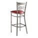 A Lancaster Table & Seating clear coat finish cross back bar stool with a detached burgundy vinyl padded seat.