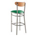 A Lancaster Table & Seating bar stool with a green vinyl seat and wood back.