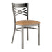 A Lancaster Table & Seating metal cross back chair with a light brown vinyl seat cushion.