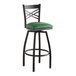 A Lancaster Table & Seating black swivel bar stool with a green vinyl cushion.