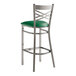 A Lancaster Table & Seating cross back bar stool with a green vinyl seat.