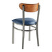 A Lancaster Table & Seating metal chair with a blue vinyl seat and back.