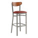 A Lancaster Table & Seating bar stool with a burgundy vinyl seat and wood back.
