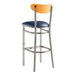 A Lancaster Table & Seating bar stool with a navy vinyl seat and cherry wood back.
