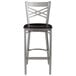 A Lancaster Table & Seating cross back bar stool with a black wood seat.