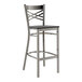 A Lancaster Table & Seating metal bar stool with black wood seat.