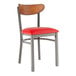 A Lancaster Table & Seating Boomerang chair with red vinyl seat and wooden back and metal legs.