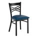 A black metal chair with a cross back design and a navy blue vinyl padded seat.