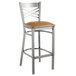 A Lancaster Table & Seating clear coat finish cross back bar stool with a light brown cushioned seat.