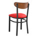 A Lancaster Table & Seating Boomerang chair with a red vinyl seat.