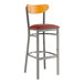 A Lancaster Table & Seating bar stool with a red vinyl seat.