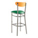 A Lancaster Table & Seating bar stool with a green vinyl seat and cherry wood back on metal legs.