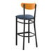 A Lancaster Table & Seating bar stool with a navy seat and black frame.