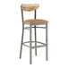 A Lancaster Table & Seating bar stool with a wooden seat and cushioned back.