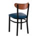 A black metal chair with a navy vinyl seat and an antique walnut wood backrest.
