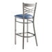A Lancaster Table & Seating metal bar stool with a navy blue padded seat.