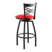 A Lancaster Table & Seating black bar stool with red cushion.