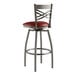 A Lancaster Table & Seating red vinyl padded swivel bar stool with a clear coat finish and silver metal frame.