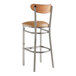 A Lancaster Table & Seating bar stool with a light brown vinyl seat and wooden back.