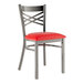 A Lancaster Table & Seating clear coat metal cross back restaurant chair with a red vinyl padded seat.