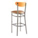 A Lancaster Table & Seating bar stool with a wooden back and light brown vinyl seat.