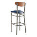 A Lancaster Table & Seating bar stool with a navy blue cushion on the seat.