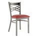 A Lancaster Table & Seating metal cross back chair with a burgundy vinyl padded seat on a white background.