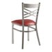 A Lancaster Table & Seating clear coat cross back chair with a burgundy vinyl padded seat.