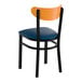 A black metal chair with a navy vinyl seat and a curved cherry wood backrest.
