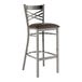 A metal bar stool with a cross back design and a dark brown padded vinyl seat.