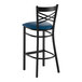 A black metal bar stool with a cross back design and a navy blue vinyl padded seat.