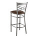 A Lancaster Table & Seating metal bar stool with a dark brown vinyl seat.