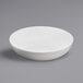 A white Elite Global Solutions melamine bowl on a gray surface.