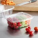 A Dart ClearPac plastic container with a lid filled with carrots and tomatoes.