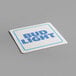 A close-up of a White Square coaster with blue text that says "bud light" on it.