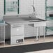 A Regency stainless steel dishtable with a sink and right drainboard.