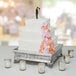 a silver box with flowers and candles