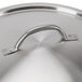 A Vollrath stainless steel pan lid with a handle and domed cover.